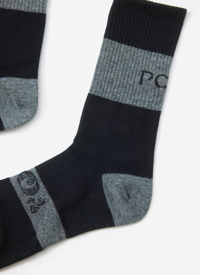 A close-up studio shot of the black and grey PCVL Performance Socks by Percival, showing the branding and ribbed details.