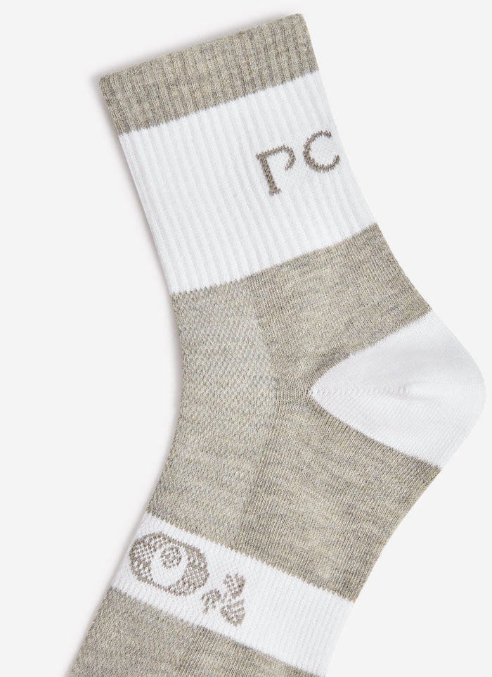 A detailed close-up of the Percival PCVL Performance Sock in white, showing the grey marl details and 'PC' branding.