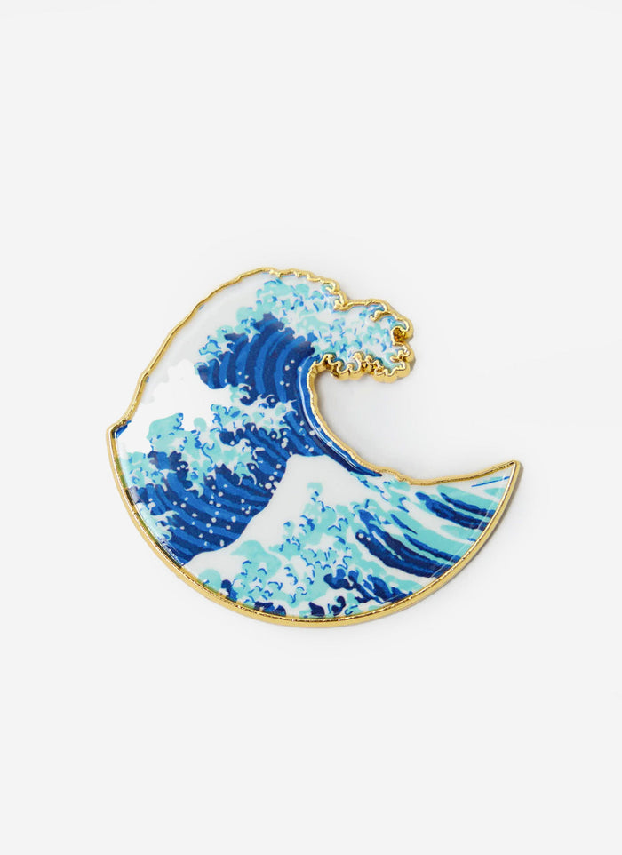 A studio shot of the Percival Wave Pin Badge, highlighting the blue and white enamel design and gold metal trim.