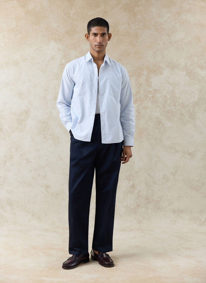 Percival blue pinstripe cotton Oxford shirt, styled on a model with navy trousers and dark leather loafers.