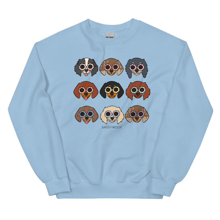 The Sassy Woof Sweatshirt - Doxies is a light blue unisex crewneck with nine cartoon dachshunds in sunglasses and “SASSY WOOF” below—fun, playful apparel for dog lovers.