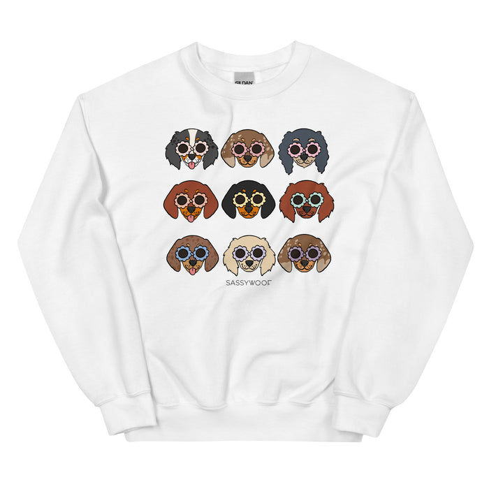 The Sassy Woof “Sweatshirt - Doxies” is a white unisex crewneck with nine illustrated dogs in sunglasses, arranged in a grid, and “SASSY WOOF” printed below—perfect stylish apparel for dog lovers.