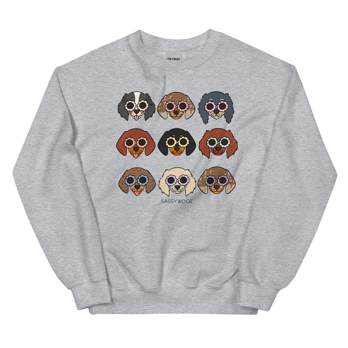 The “Sweatshirt - Doxies” by Sassy Woof is a gray unisex crewneck with nine cartoon dachshunds in shades, arranged 3x3, “SASSYWOOF” below. Each doxie features unique fur and sunglasses—a fun pick for any dog lover’s wardrobe.