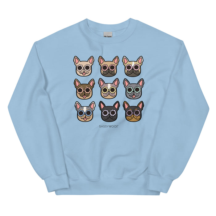 The Sweatshirt - Frenchies by Sassy Woof is a light blue unisex crewneck with a 3x3 grid of cartoon French Bulldog faces in colorful glasses above the text SASSY WOOF—perfect for dog lovers.