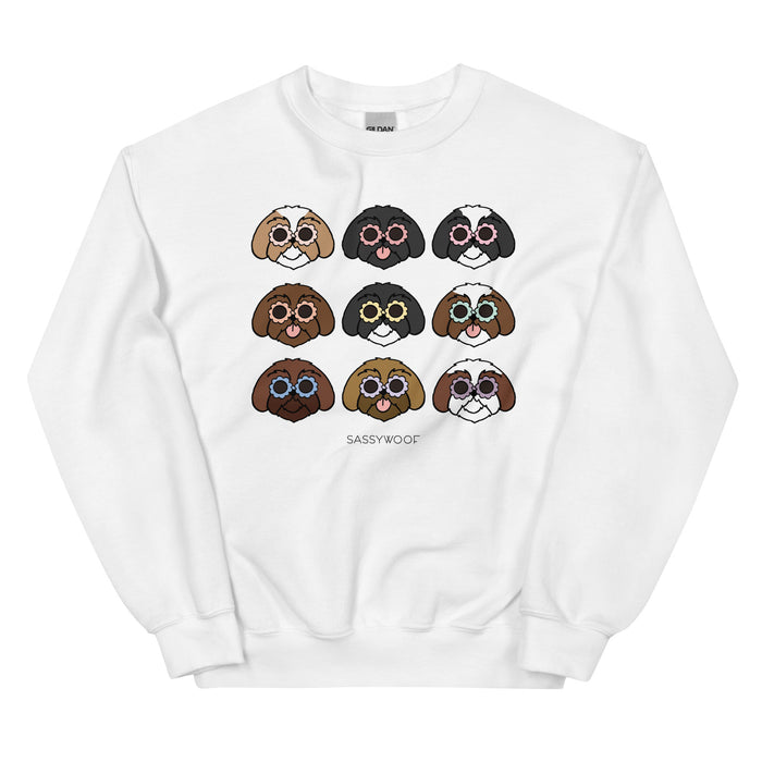 The Sassy Woof "Sweatshirt - Shih Tzus" features nine colorful cartoon Shih Tzu faces with sunglasses above “SASSYWOOF.” This unisex sweatshirt is a perfect gift for dog lovers.
