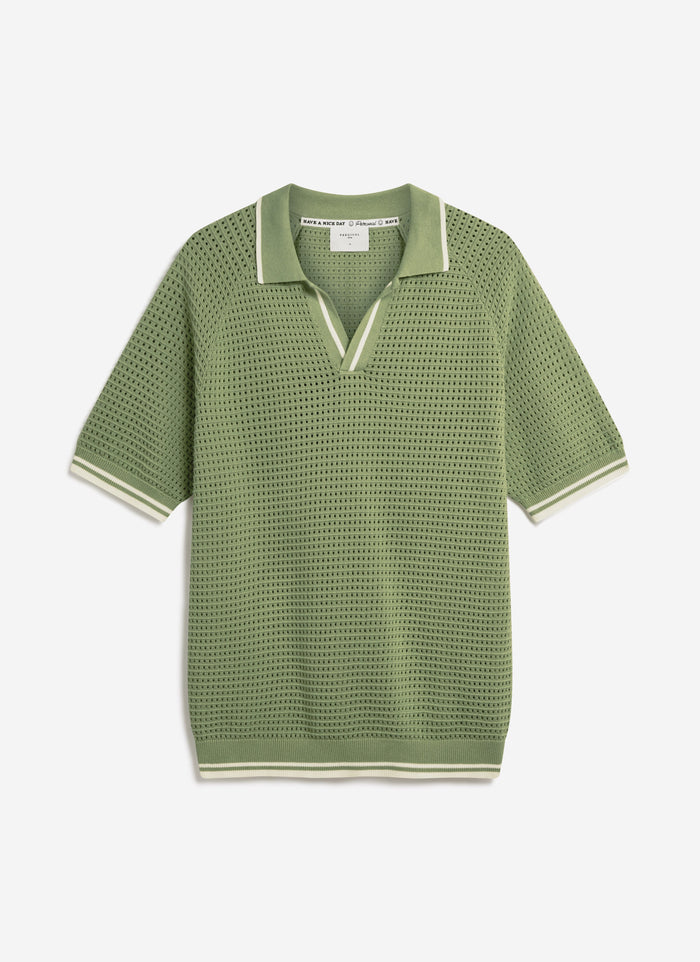 A flat lay of the Percival Tennis Boxy Knitted Polo in sage, featuring a perforated cotton knit and striped details.