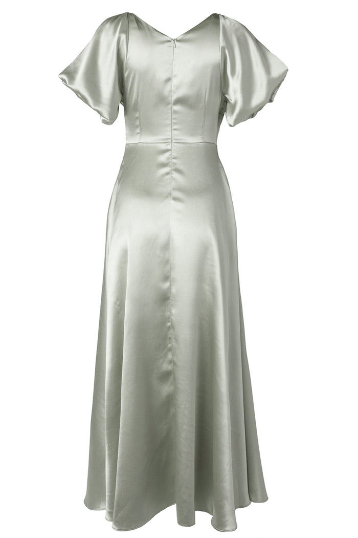 The Tessie Dress in Sage by Ivy City Co features a sage green satin fabric, short flutter sleeves, a fitted waist, and a flared skirt, shown against a plain white background—an elegant option for bridesmaids seeking a modest look or anyone searching for a sophisticated dress for special occasions.